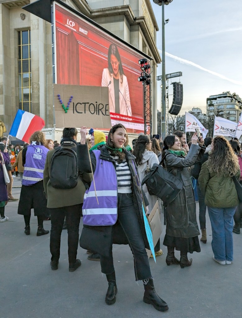Woman holding a "victory" sign.