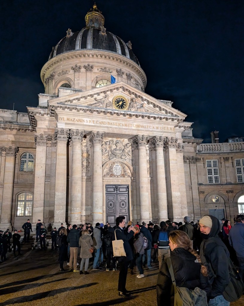 Protesting Peter Thiel's presence at the Institute de France in January 2026.
